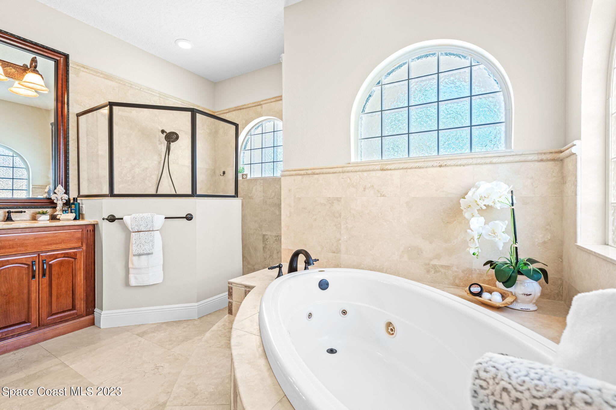 3308 Cappio Drive Melbourne, FL 32940 - Photo 14 of 42 a bathroom with a bathtub a sink and a window