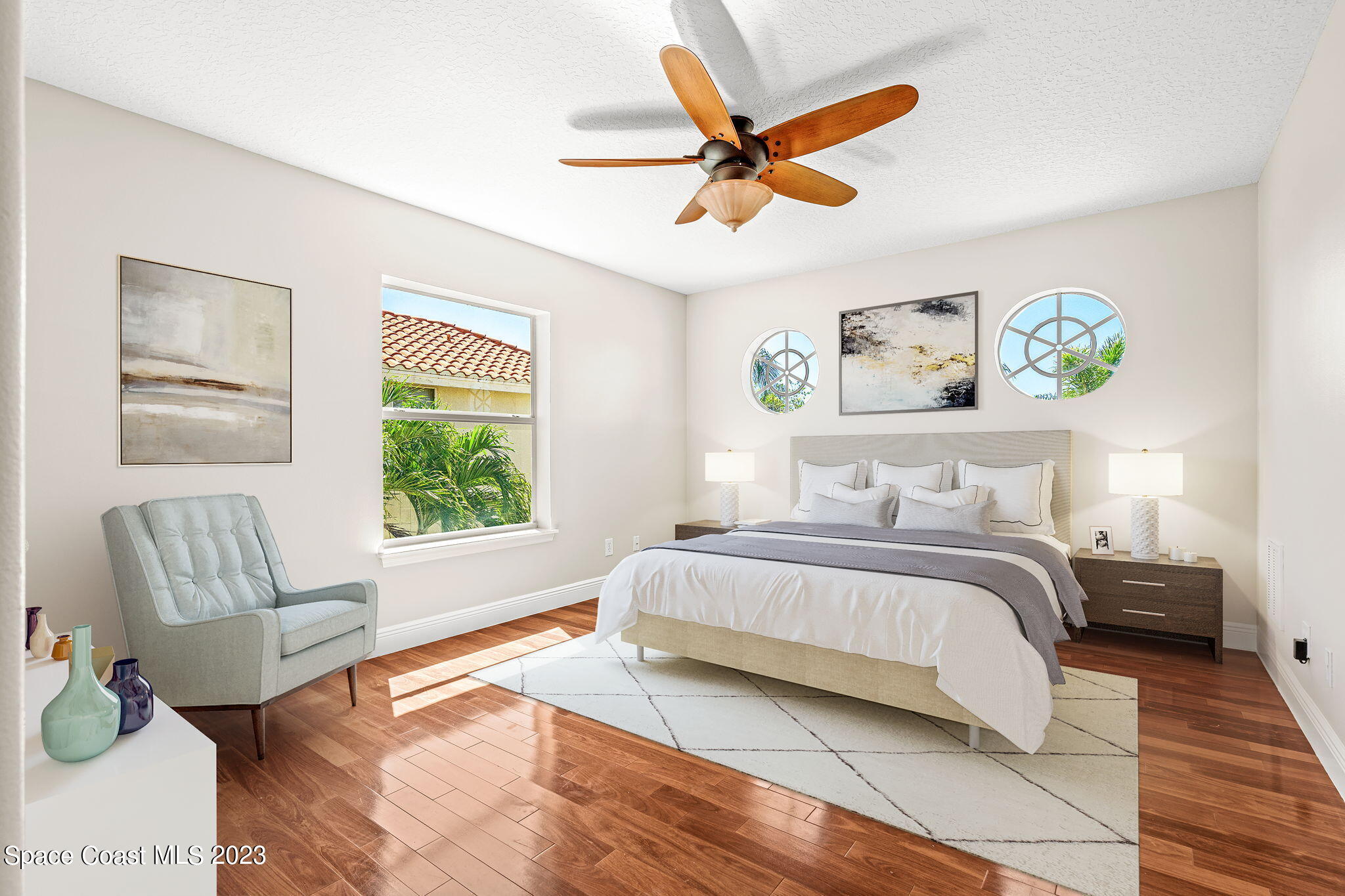 3308 Cappio Drive Melbourne, FL 32940 - Photo 23 of 42 a spacious bedroom with a bed a couch and a window
