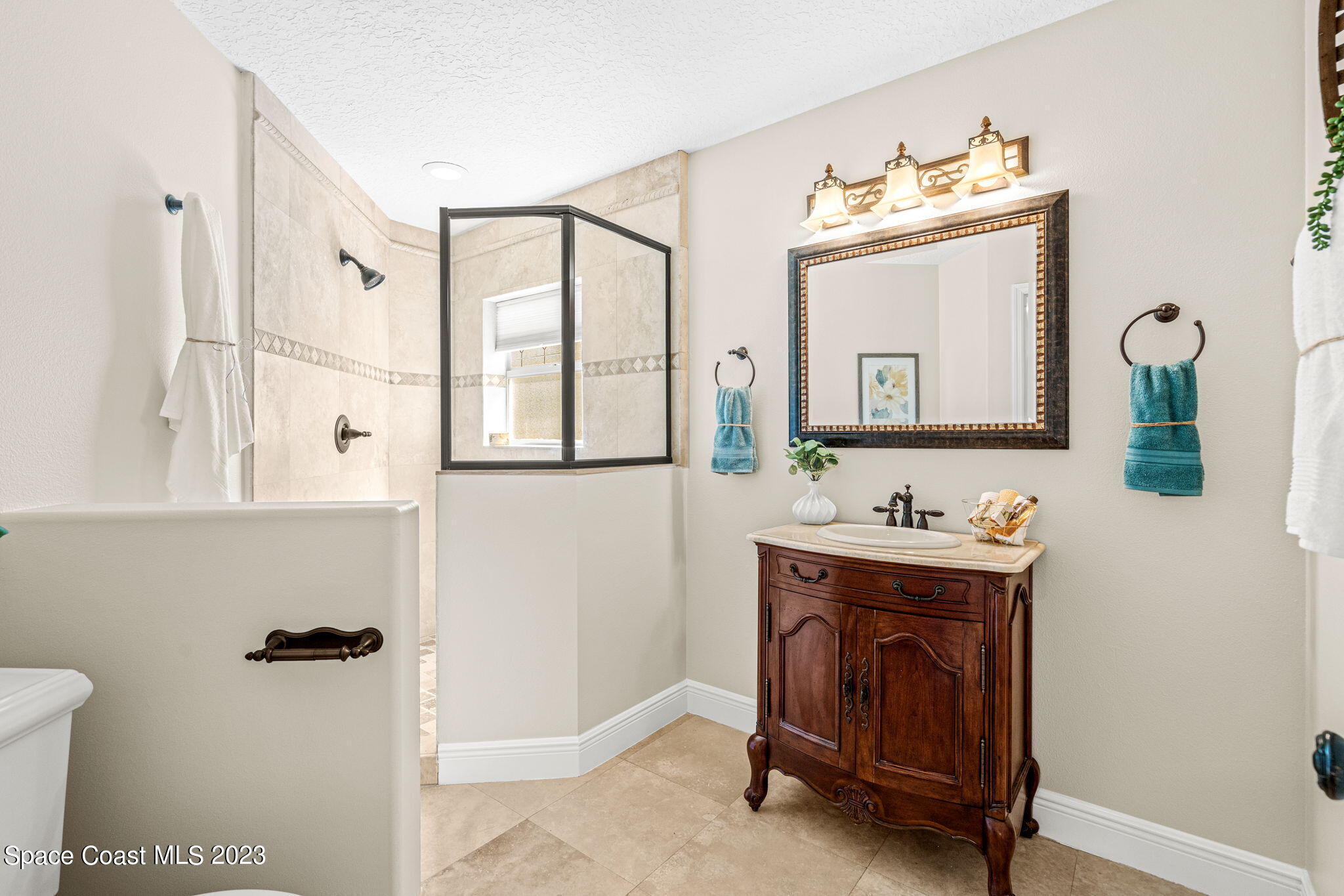 3308 Cappio Drive Melbourne, FL 32940 - Photo 24 of 42 a bathroom with a sink mirror and vanity