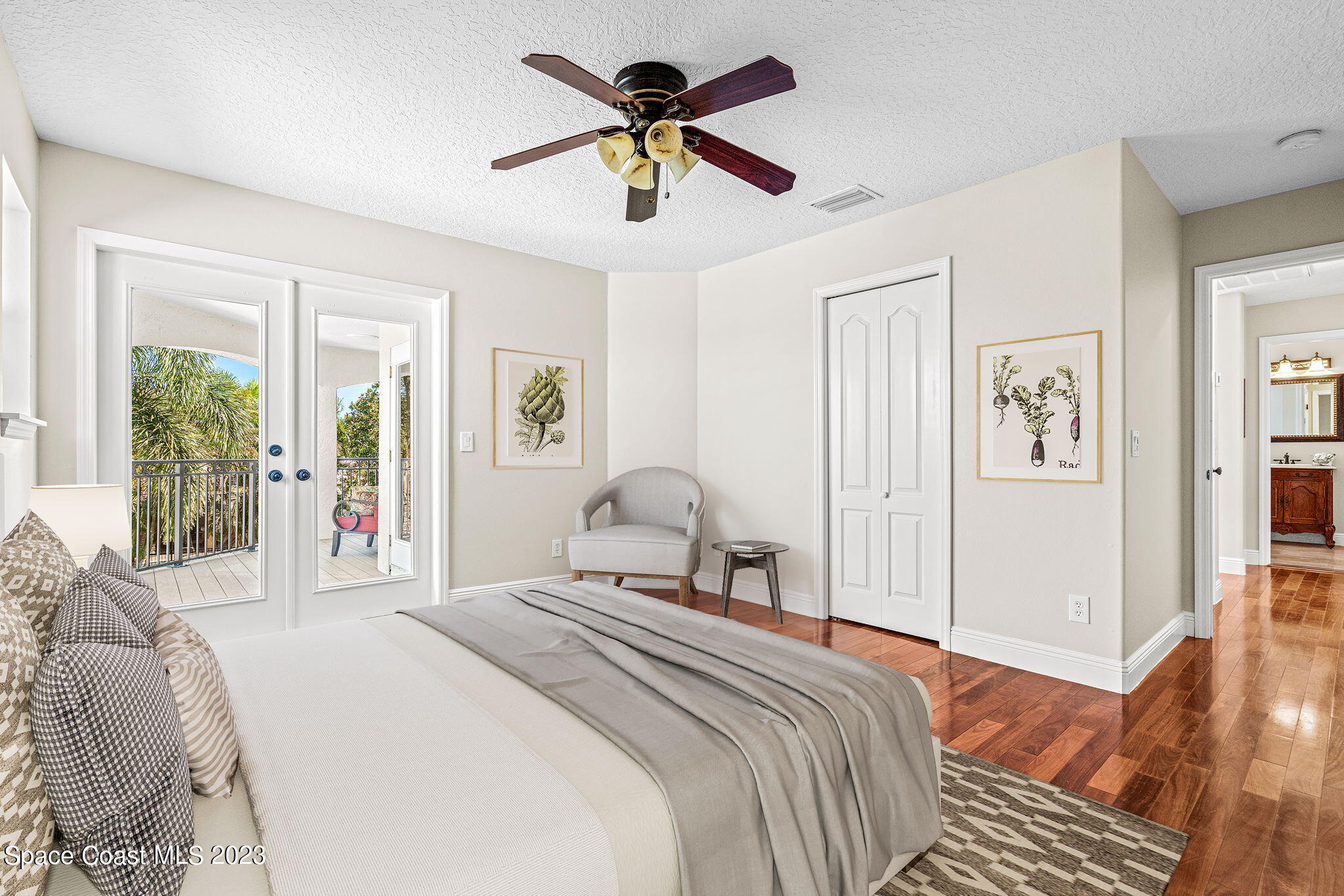 3308 Cappio Drive Melbourne, FL 32940 - Photo 25 of 42 a bedroom with a bed and a chandelier