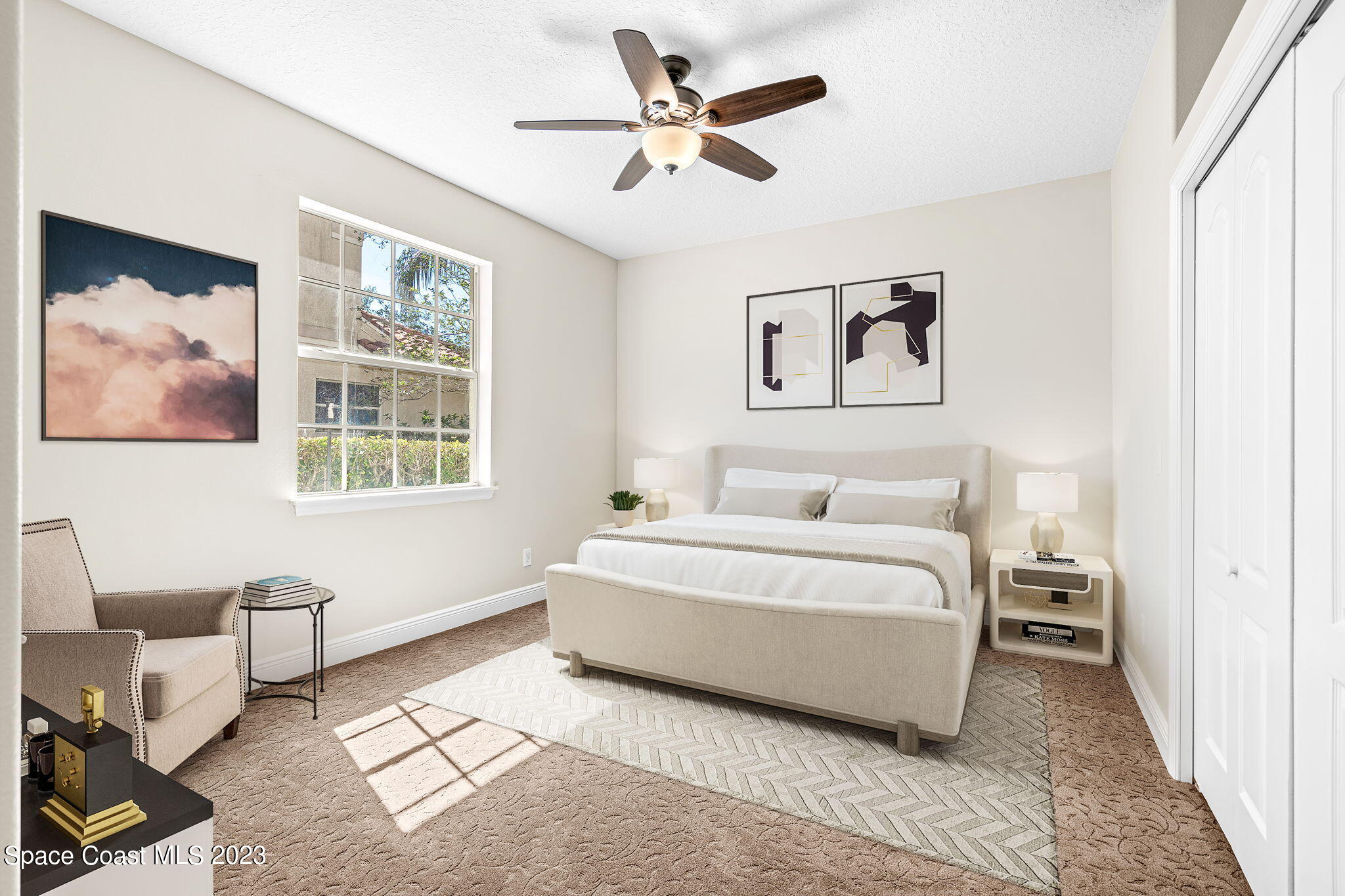 3308 Cappio Drive Melbourne, FL 32940 - Photo 26 of 42 a spacious bedroom with a bed and a couch