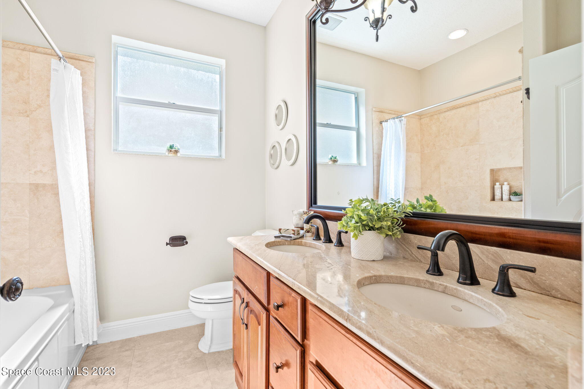 3308 Cappio Drive Melbourne, FL 32940 - Photo 27 of 42 a bathroom with a granite countertop sink and a mirror