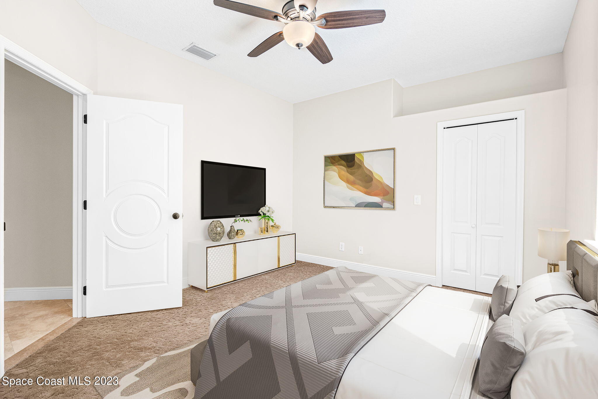 3308 Cappio Drive Melbourne, FL 32940 - Photo 28 of 42 a bedroom with a bed and a flat screen tv