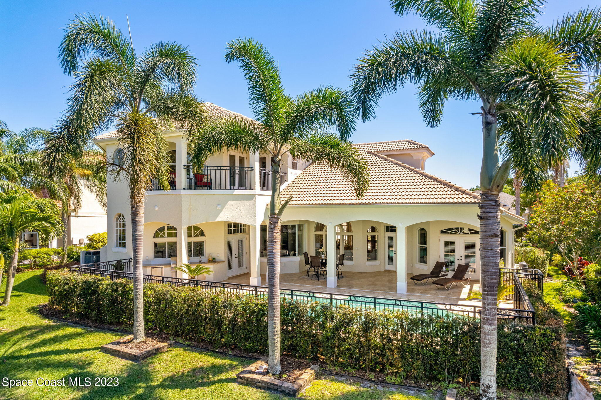 3308 Cappio Drive Melbourne, FL 32940 - Photo 35 of 42 a view of a white house with a large windows and a palm tree