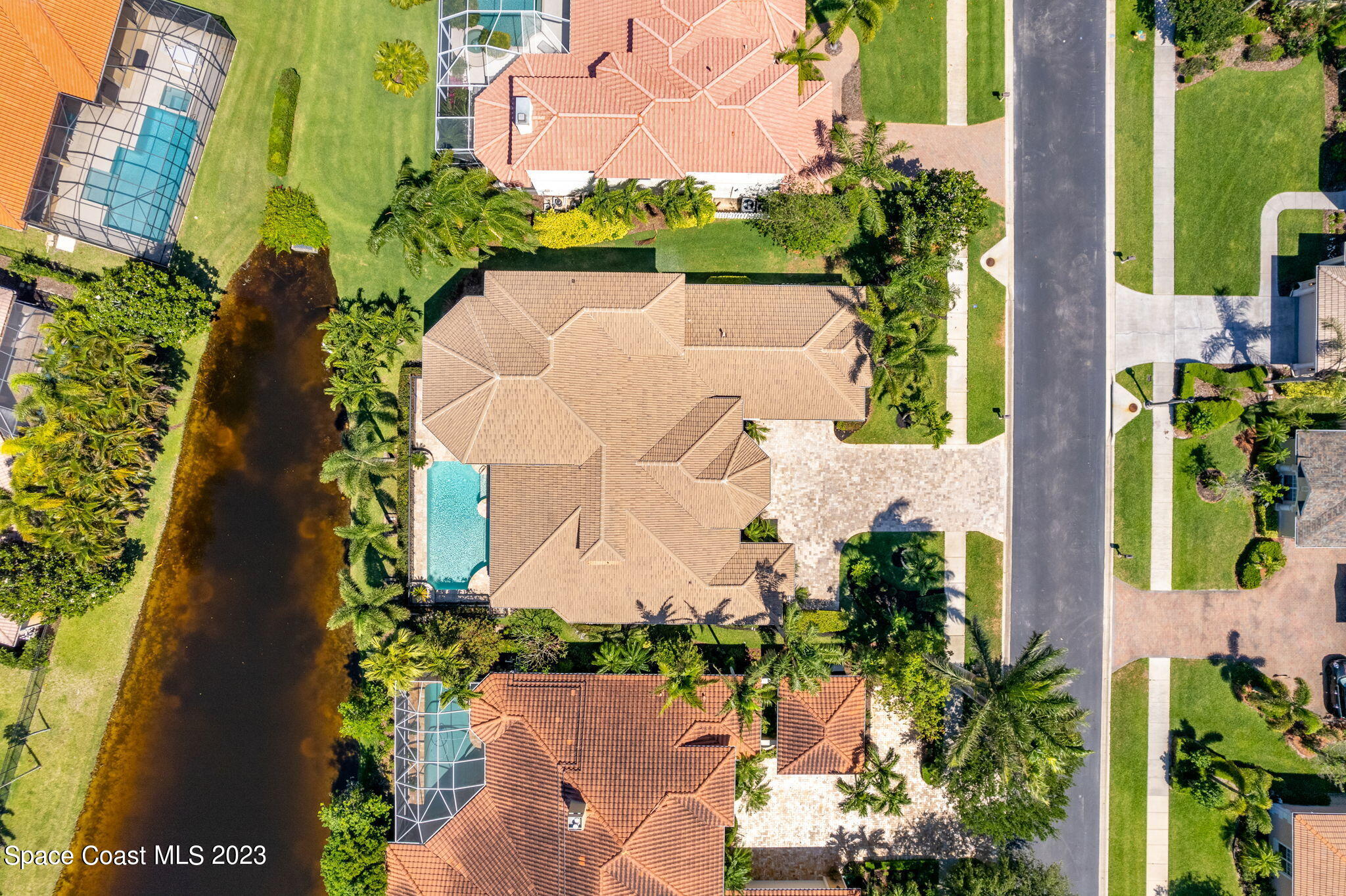 3308 Cappio Drive Melbourne, FL 32940 - Photo 40 of 42 an aerial view of a house with a garden and yard
