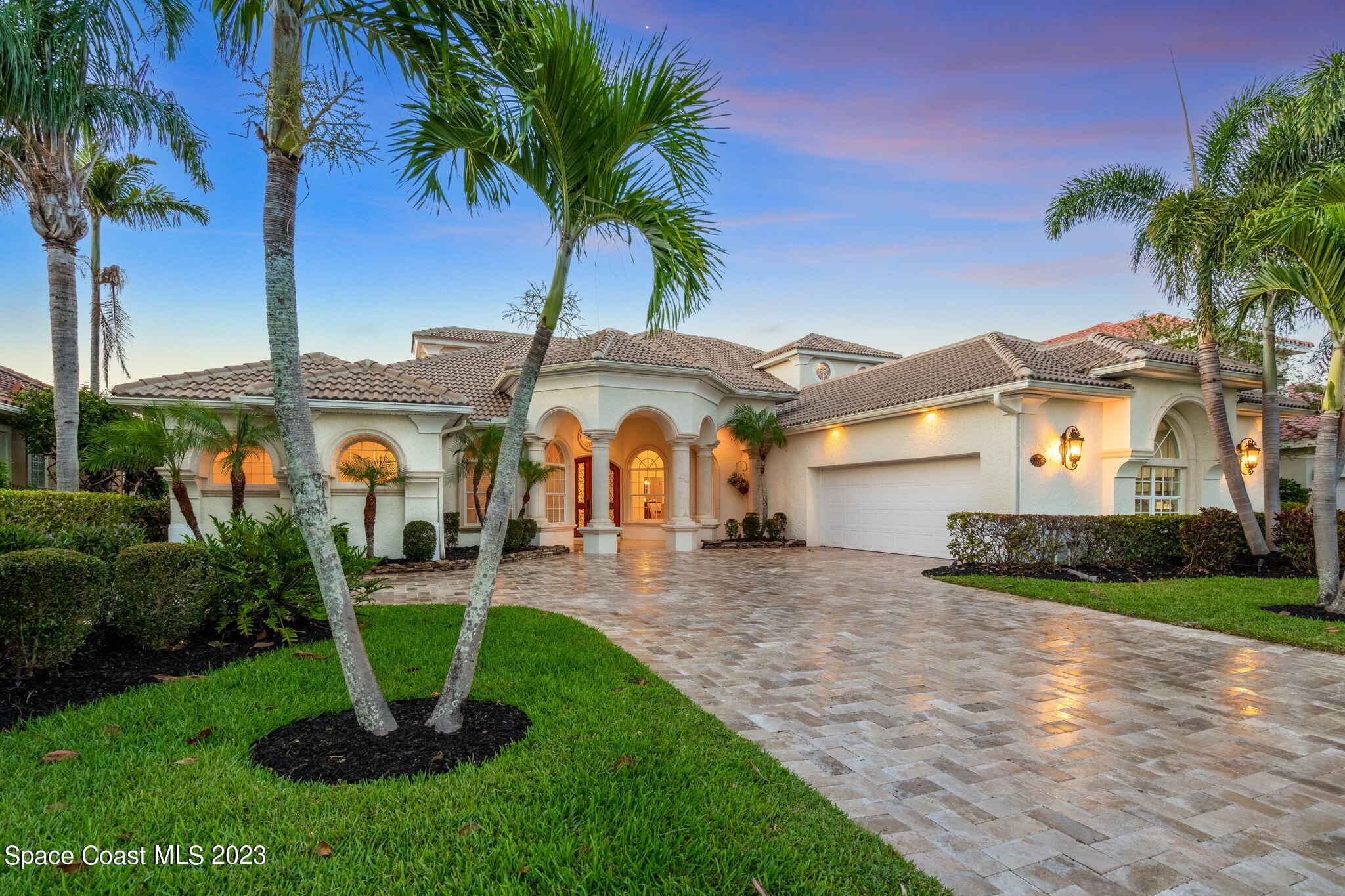 3308 Cappio Drive Melbourne, FL 32940 - Photo 41 of 42 a front view of a house with a yard and palm trees