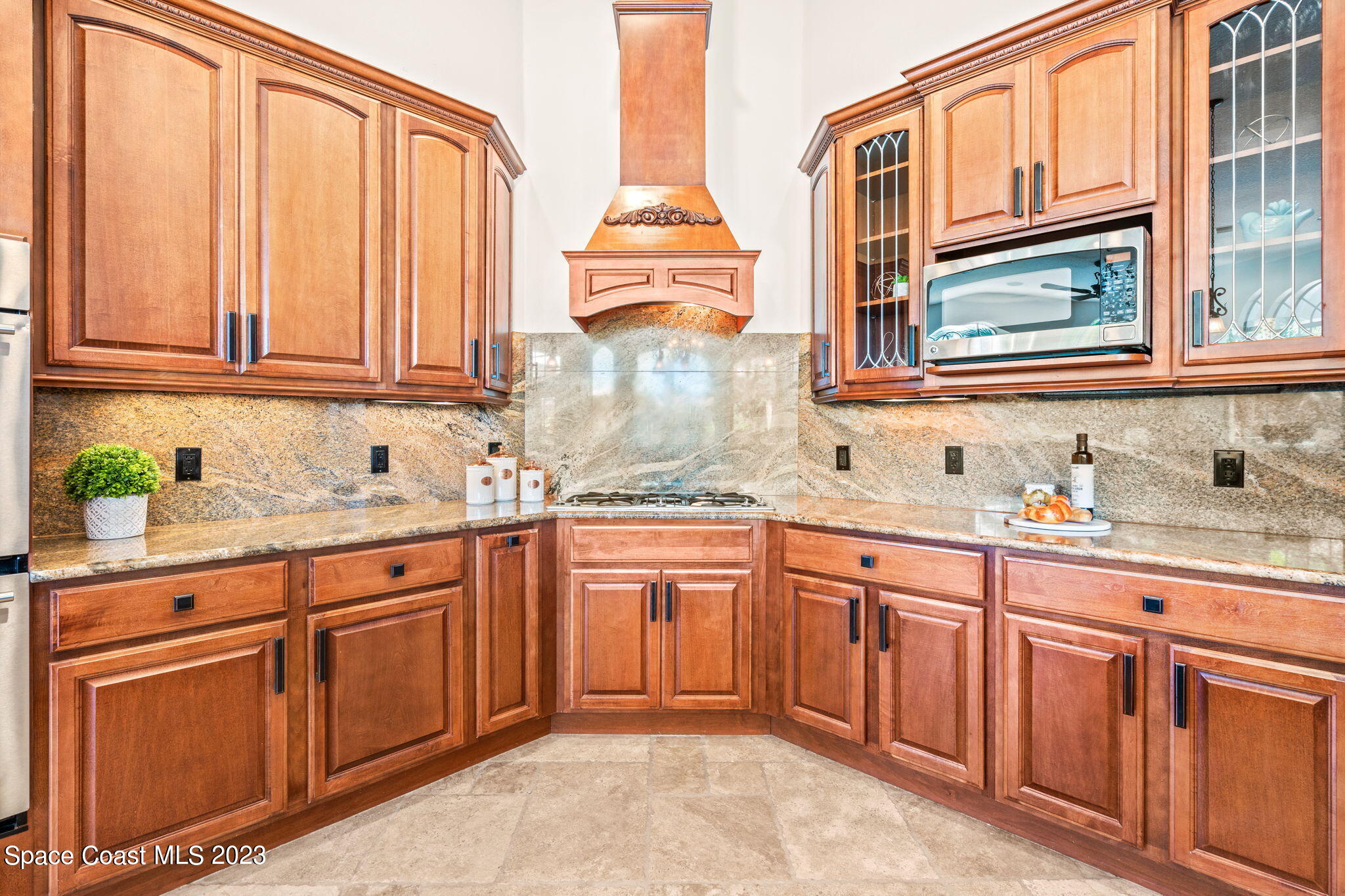 3308 Cappio Drive Melbourne, FL 32940 - Photo 7 of 42 a kitchen with granite countertop a sink stainless steel appliances and cabinets