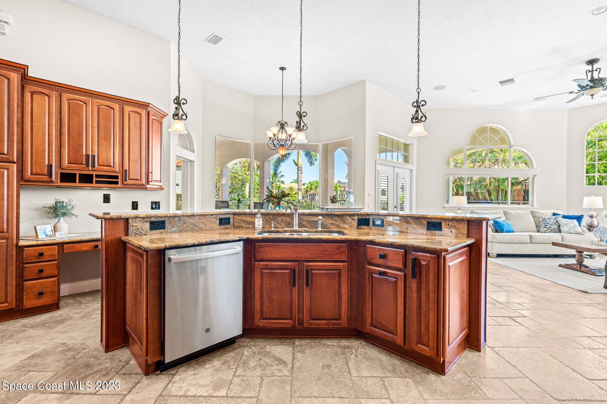 3308 Cappio Drive Melbourne, FL 32940 - Photo 8 of 42 a kitchen with stainless steel appliances granite countertop wooden cabinets a stove and a sink