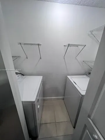 a view of storage and utility room with racks on the wall