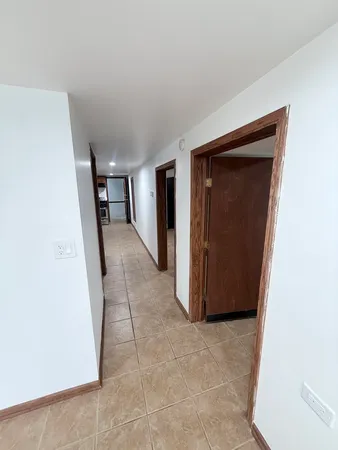 a view of a hallway to rooms