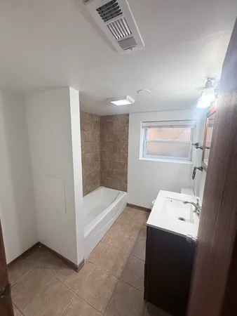 a bathroom with a bathtub sink and toilet
