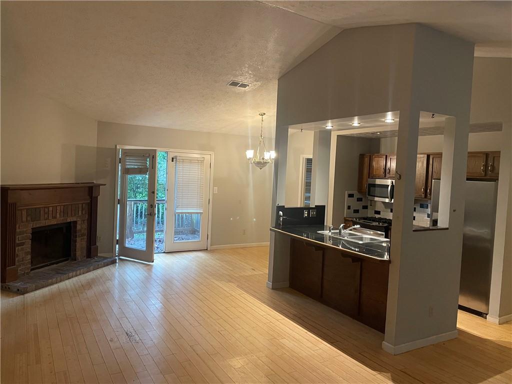 5341 Goodwick Way Northwest Norcross, GA 30071 - Photo 2 of 5 a view of a kitchen with kitchen island wooden floor and stainless steel appliances