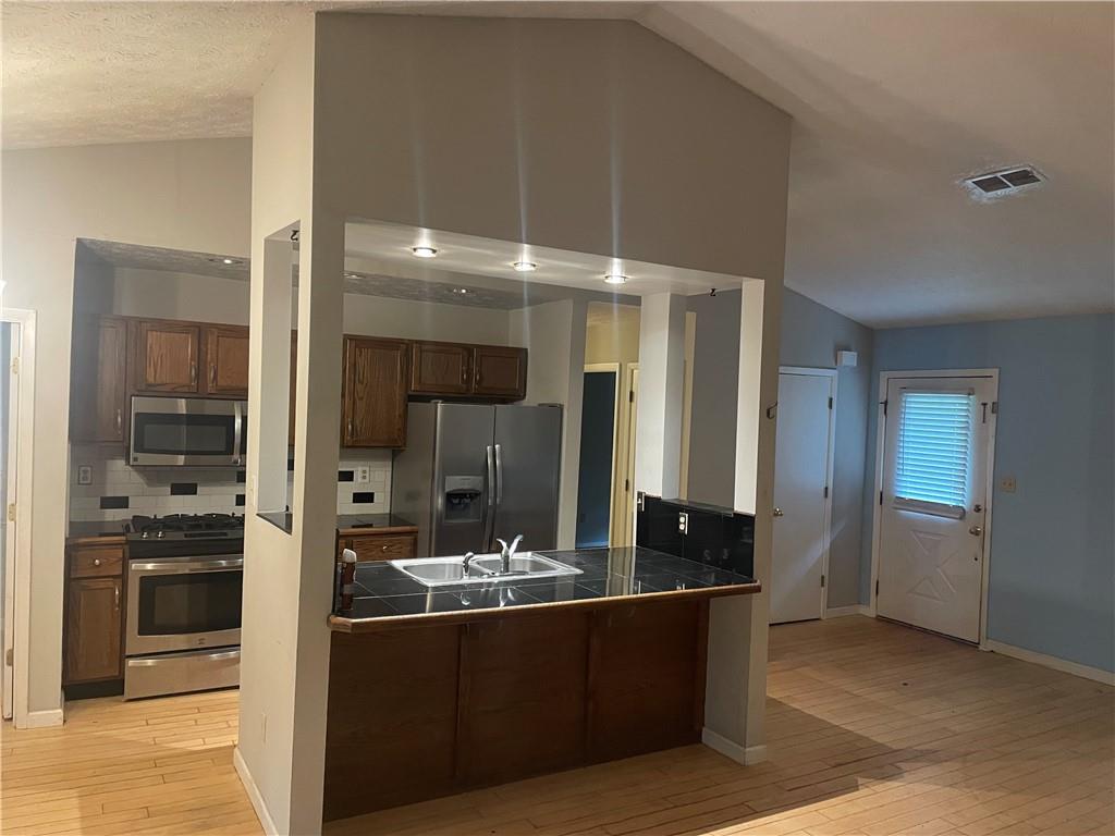 5341 Goodwick Way Northwest Norcross, GA 30071 - Photo 3 of 5 a bathroom with a sink and a large mirror