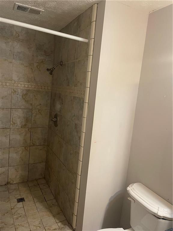 5341 Goodwick Way Northwest Norcross, GA 30071 - Photo 4 of 5 a bathroom with a toilet and a shower