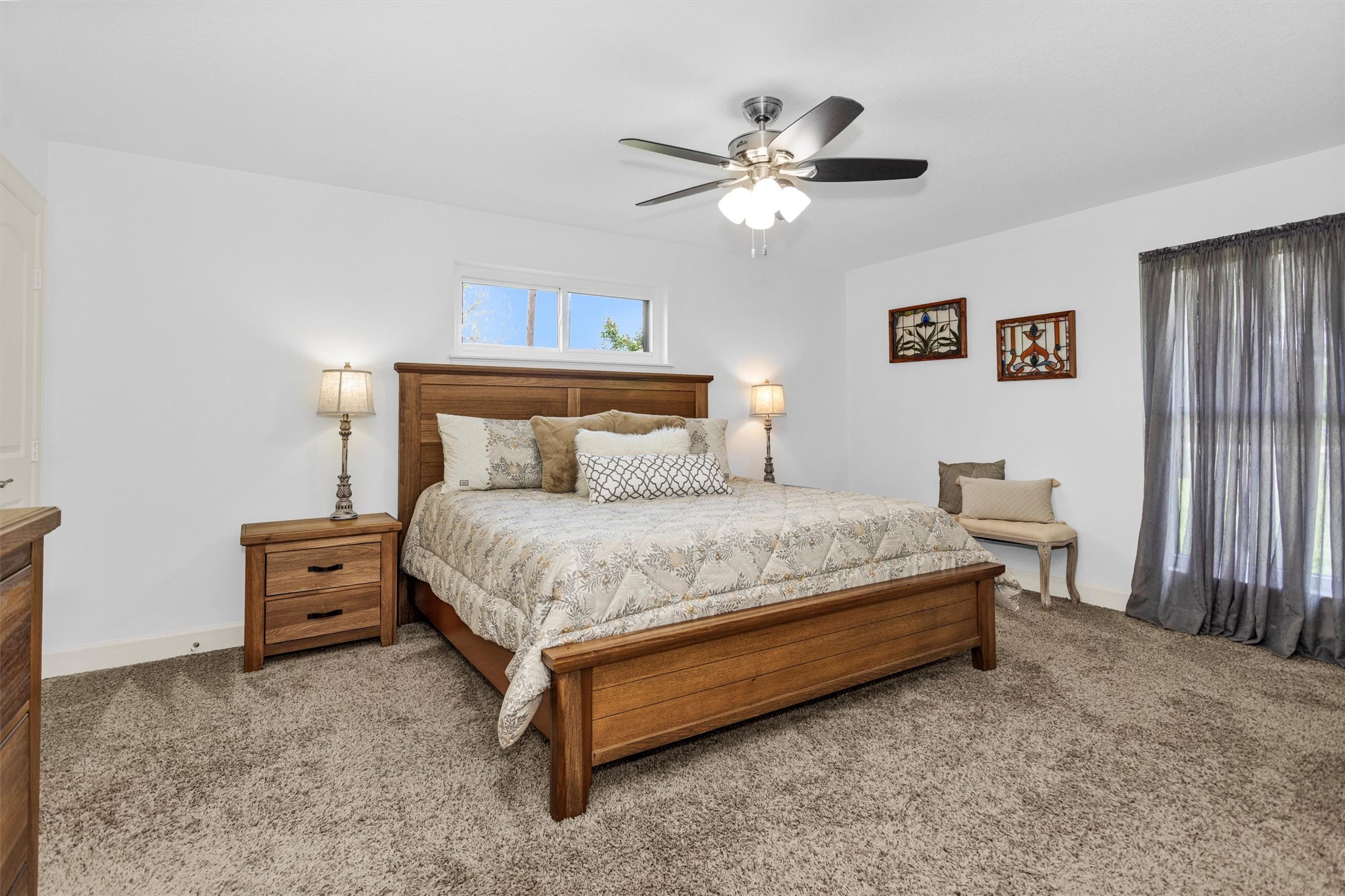 4402 Spears Road Manvel, TX 77578 - Photo 21 of 38 a spacious bedroom with a bed and a chandelier