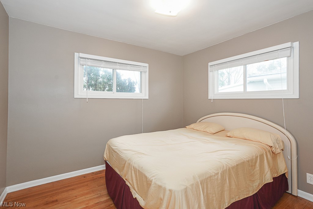 6456 Longridge Road Cleveland, OH 44124 - Photo 18 of 31 Bedroom featuring dark hardwood / wood-style floors and multiple windows