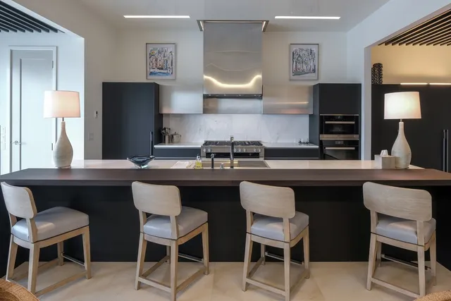 a kitchen with a table chairs sink and cabinets