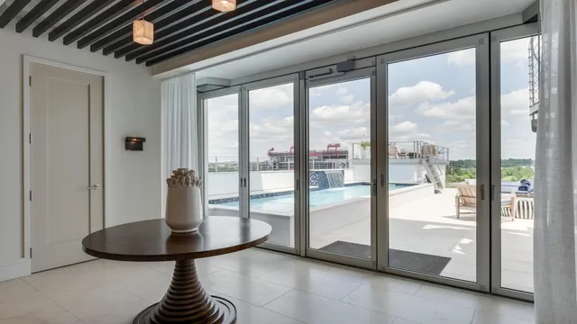 a view of a livingroom with a glass top table and chairs