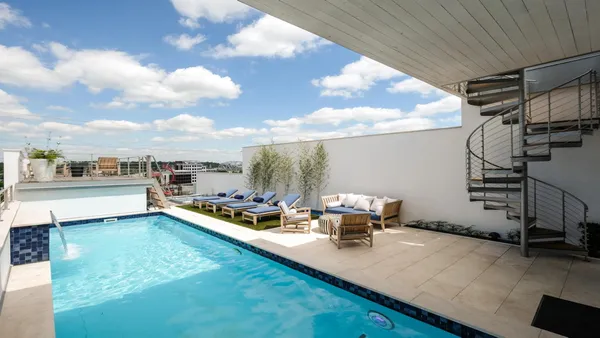 a view of a swimming pool with sitting area