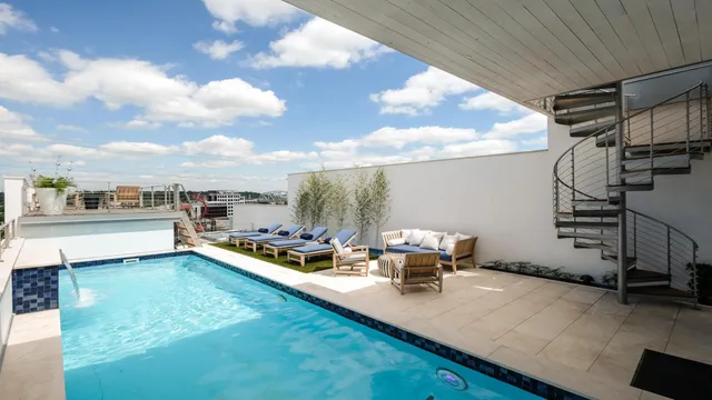 a view of a swimming pool with sitting area