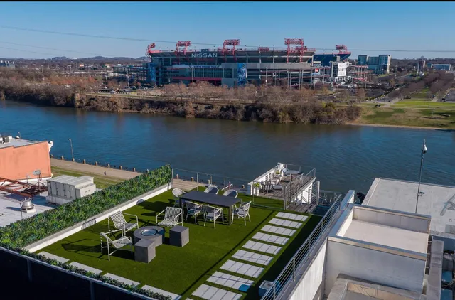 an aerial view of a house with outdoor seating