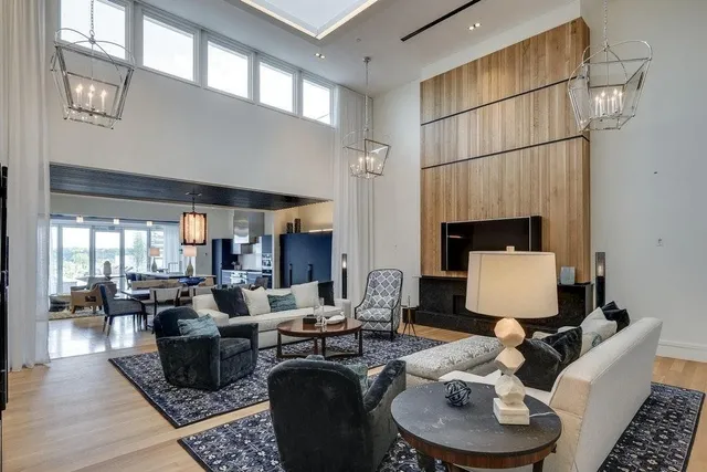 a living room with furniture a fireplace and a table