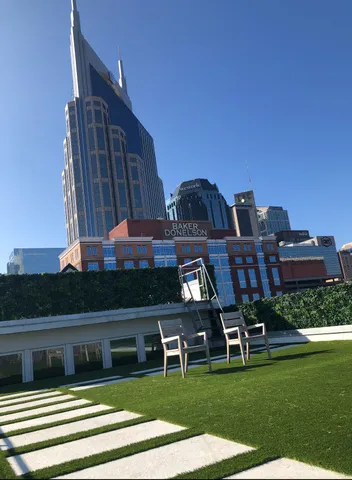 a view of a chairs and table in the grass