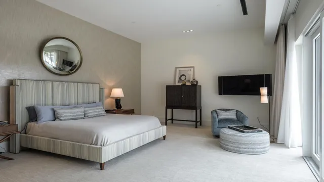 a bedroom with a bed and glass window