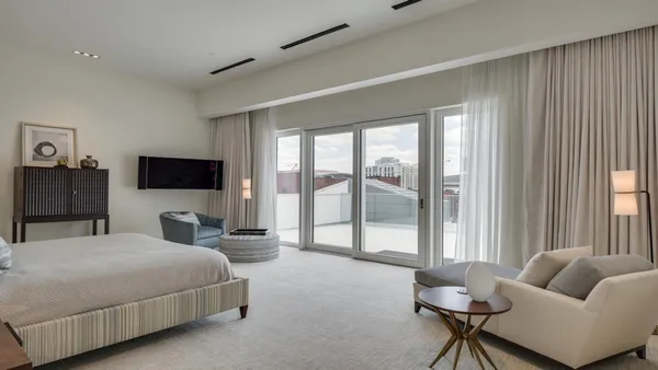 a bed room with a bed and a chair