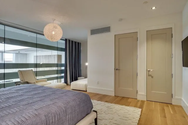 a bedroom with a bed and a mirror