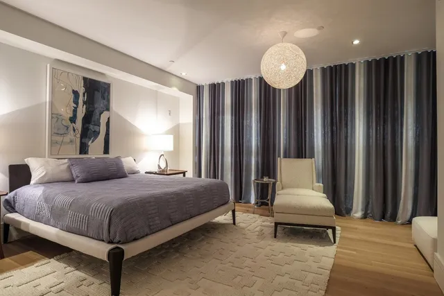 a bedroom with a bed and a television