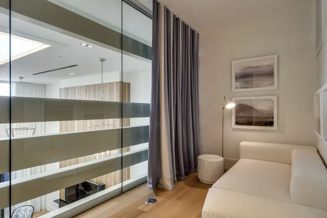 a view of red wall with a tree in it