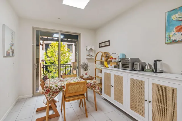 a dining room with furniture and a window