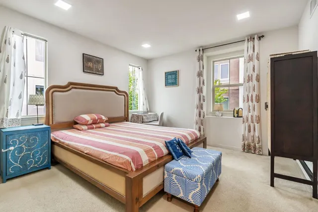 a bedroom with a bed dresser and a window