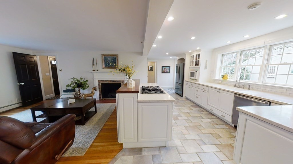 192 Berwick Road Attleboro, MA 02703 - Photo 12 of 42 a living room with furniture a large window and a fireplace