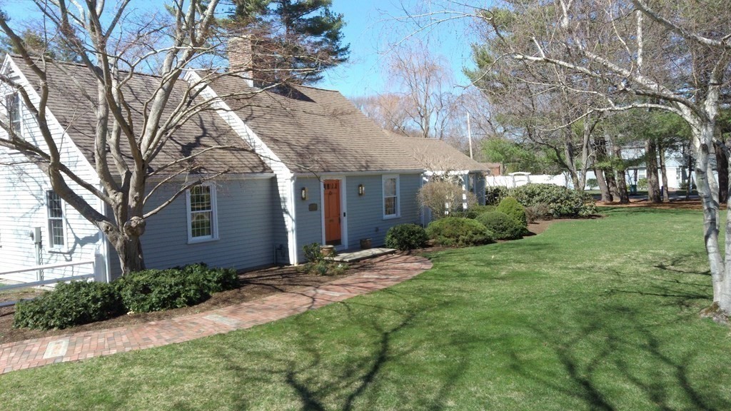 192 Berwick Road Attleboro, MA 02703 - Photo 37 of 42 a view of a brick house with a large windows and large trees