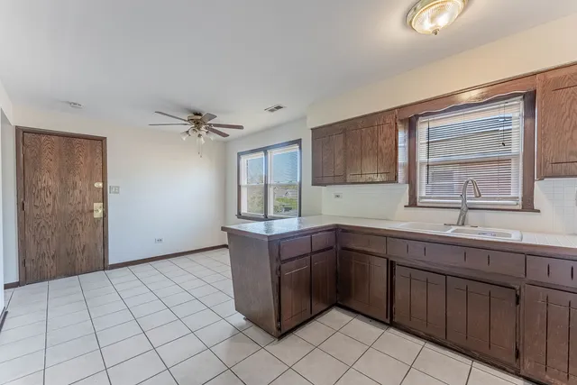 a kitchen with a sink cabinets and window