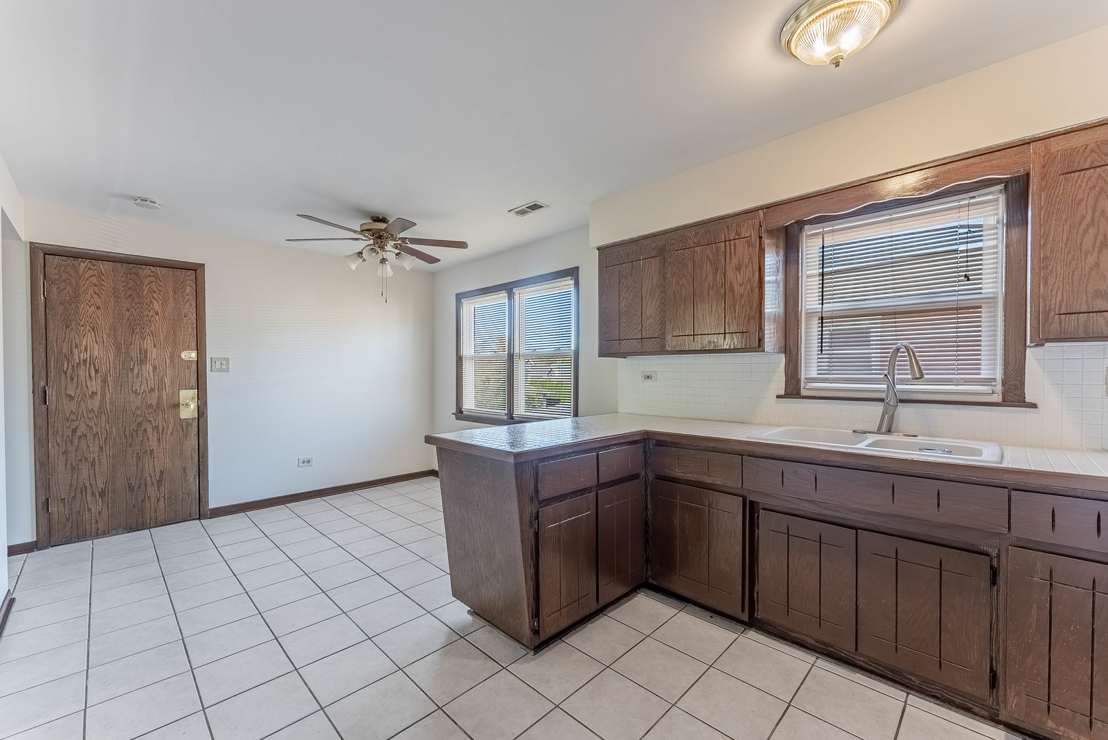 7560 Banks Street, Unit 2 Justice, IL 60458 - Photo 13 of 14 a kitchen with a sink cabinets and window