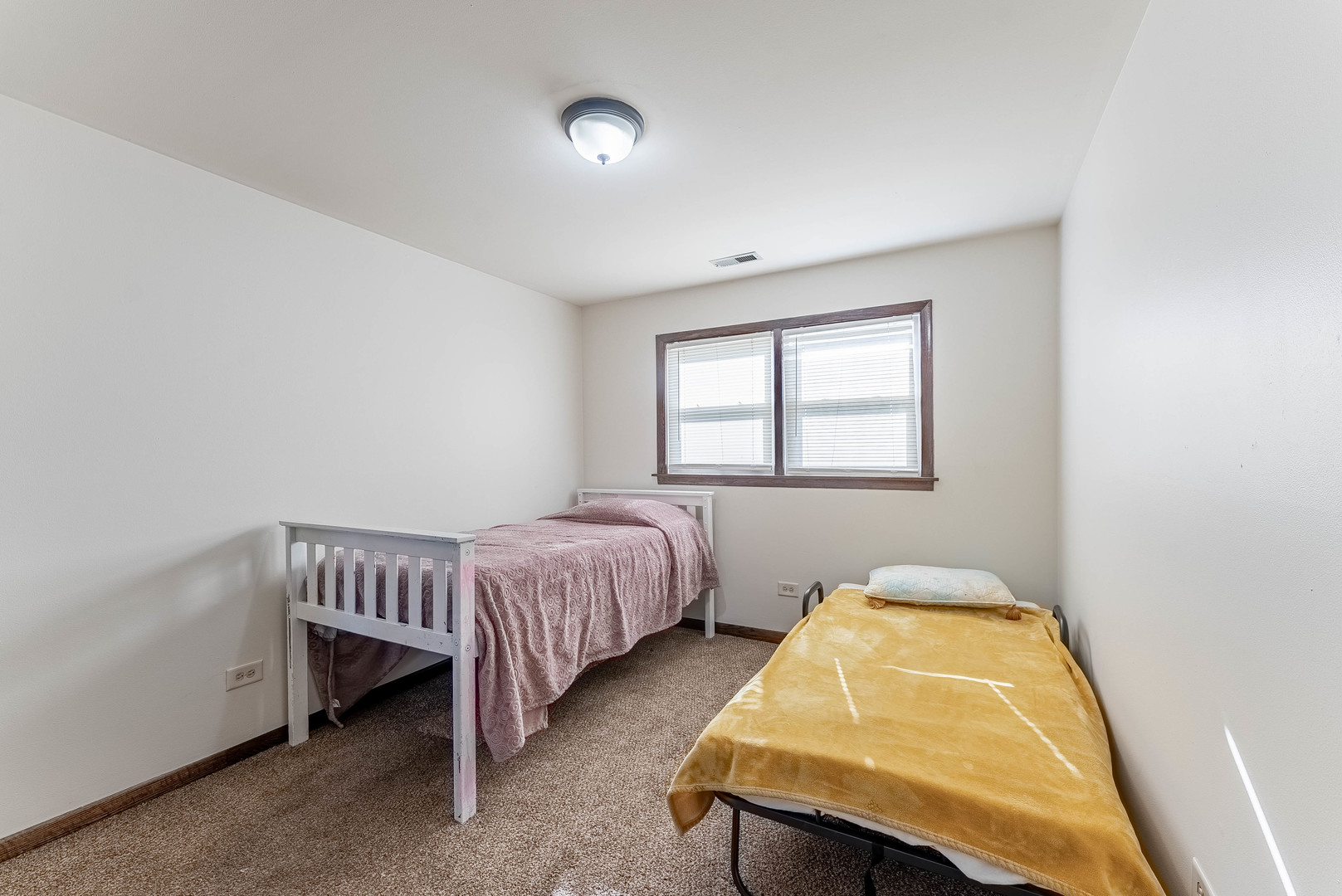 7560 Banks Street, Unit 2 Justice, IL 60458 - Photo 7 of 14 a bedroom with a bed and a window