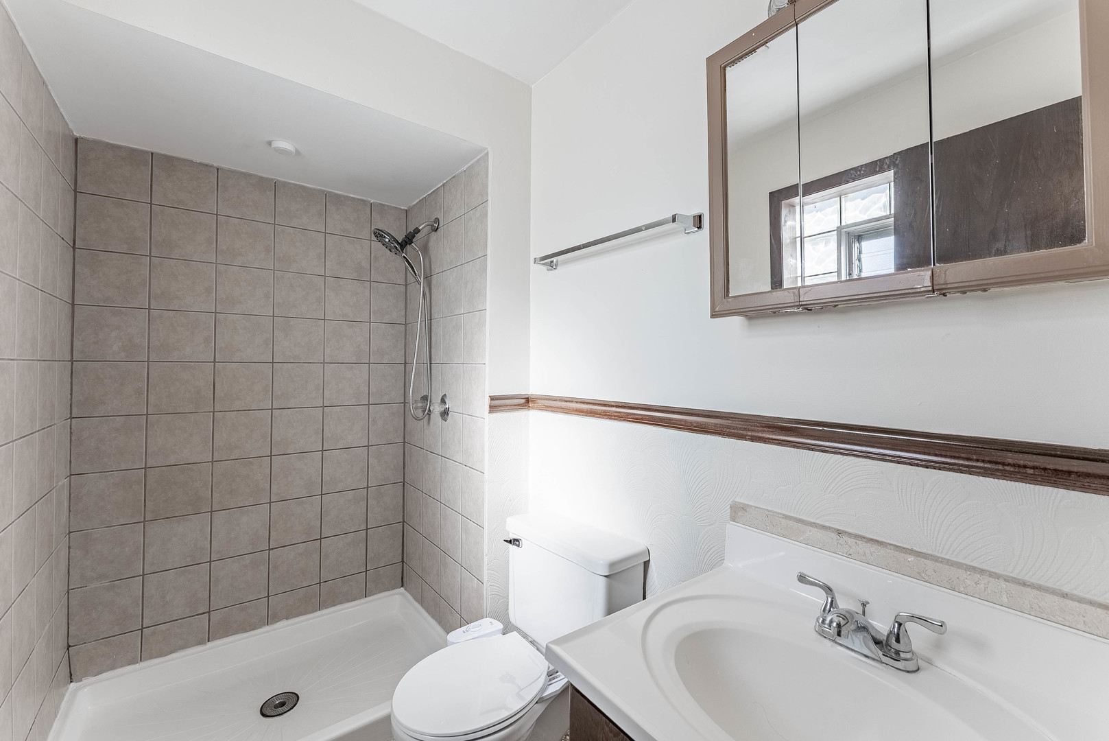 7560 Banks Street, Unit 2 Justice, IL 60458 - Photo 10 of 14 a bathroom with a sink a toilet and shower