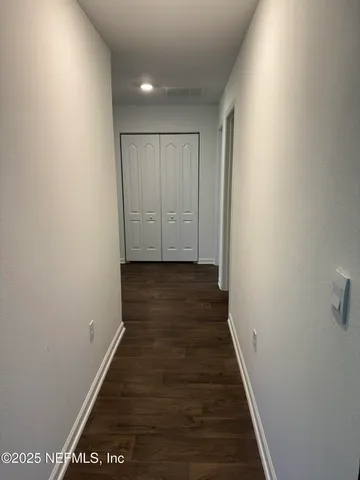 an entryway with a cabinet and a window