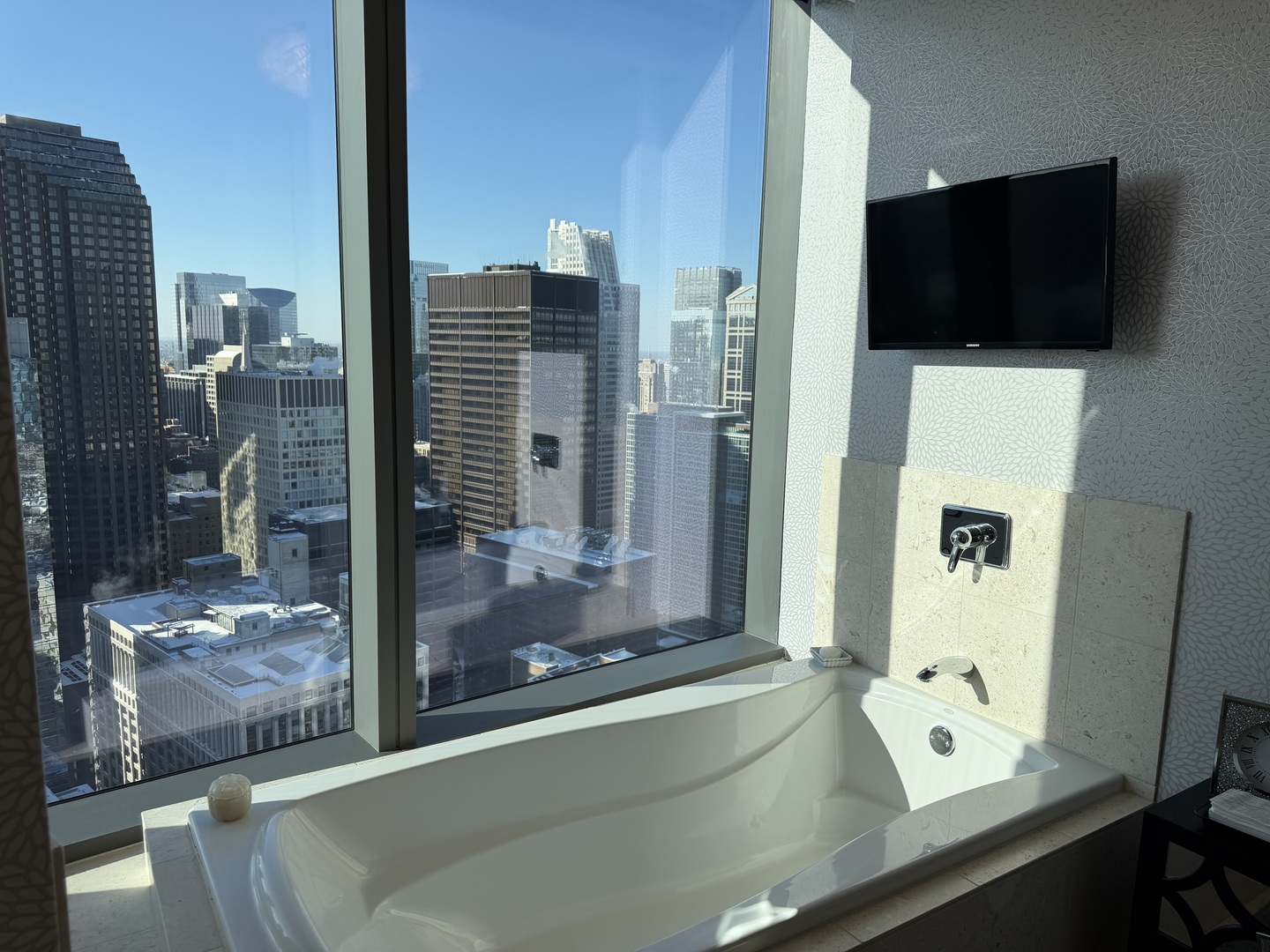 60 East Monroe Street, Unit 4906 Chicago, IL 60603 - Photo 9 of 14 a room with a large window and a flat screen tv