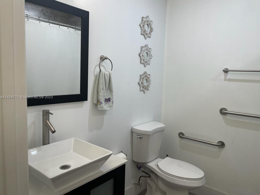 Silver Falls Miramar, FL 33027 - Photo 17 of 24 a white toilet sitting next to a bathroom sink