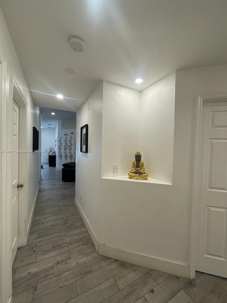 Silver Falls Miramar, FL 33027 - Photo 18 of 24 a view of a hallway with wooden floor