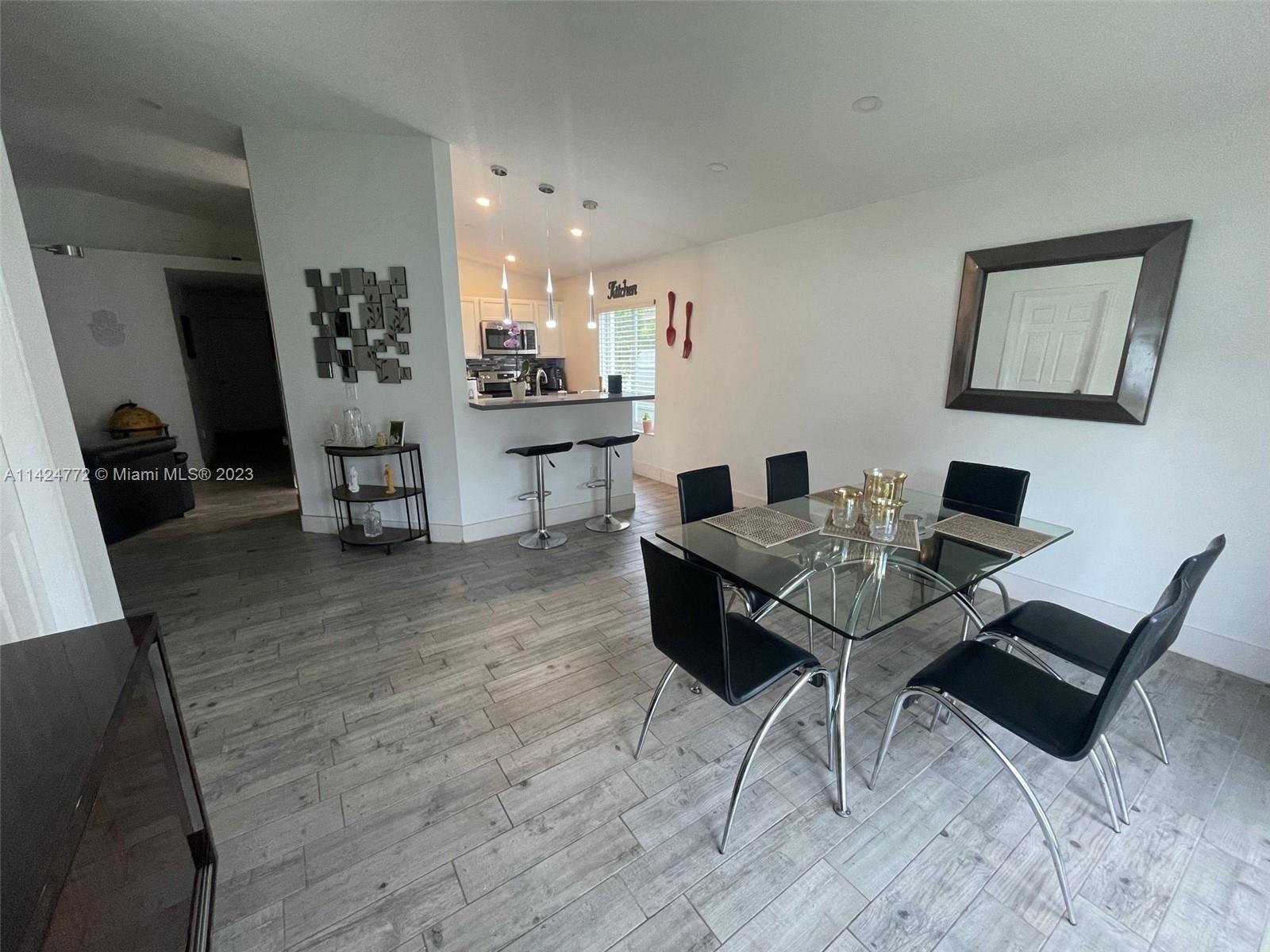 Silver Falls Miramar, FL 33027 - Photo 8 of 24 a view of a dining room with furniture and wooden floor