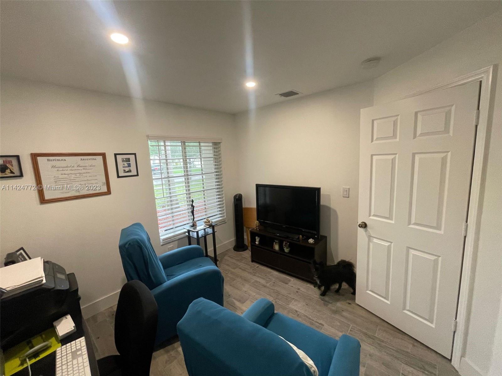 Silver Falls Miramar, FL 33027 - Photo 9 of 24 a living room with furniture a flat screen tv and a window