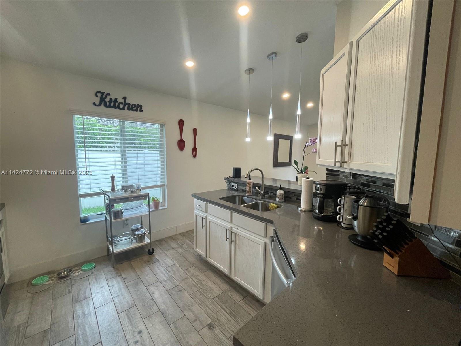 Silver Falls Miramar, FL 33027 - Photo 10 of 24 a kitchen with sink a stove and chairs