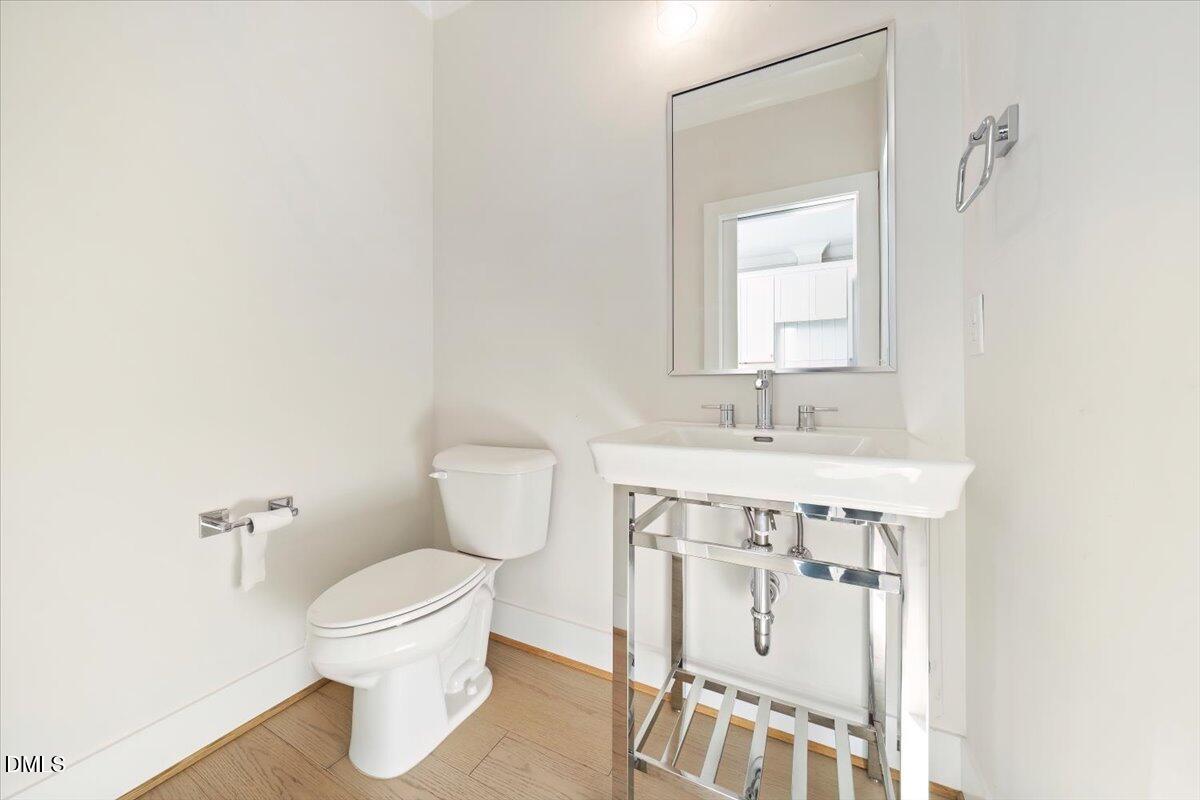 712 East Edenton Street, Unit 102 Raleigh, NC 27601 - Photo 13 of 17 a bathroom with a sink toilet and mirror
