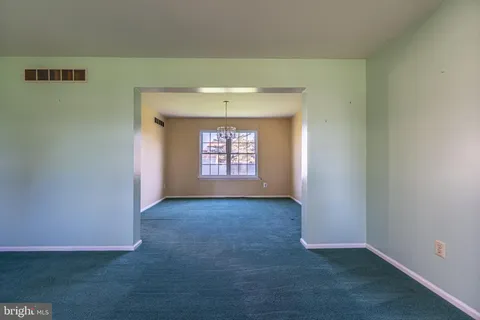 a dining room with furniture a large window and wooden floor