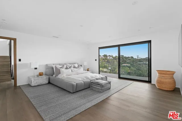 a bedroom with a bed and glass window